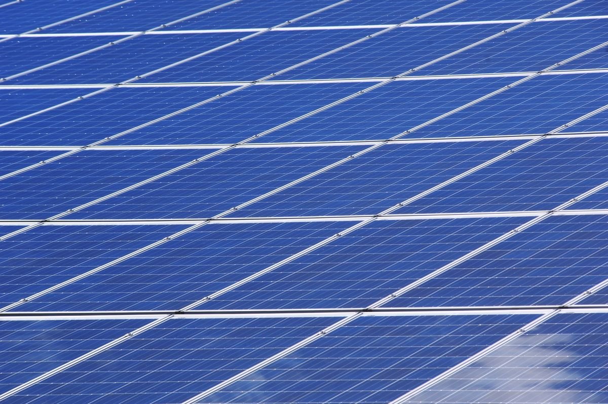 Solar technician installing panels on Kerala rooftop